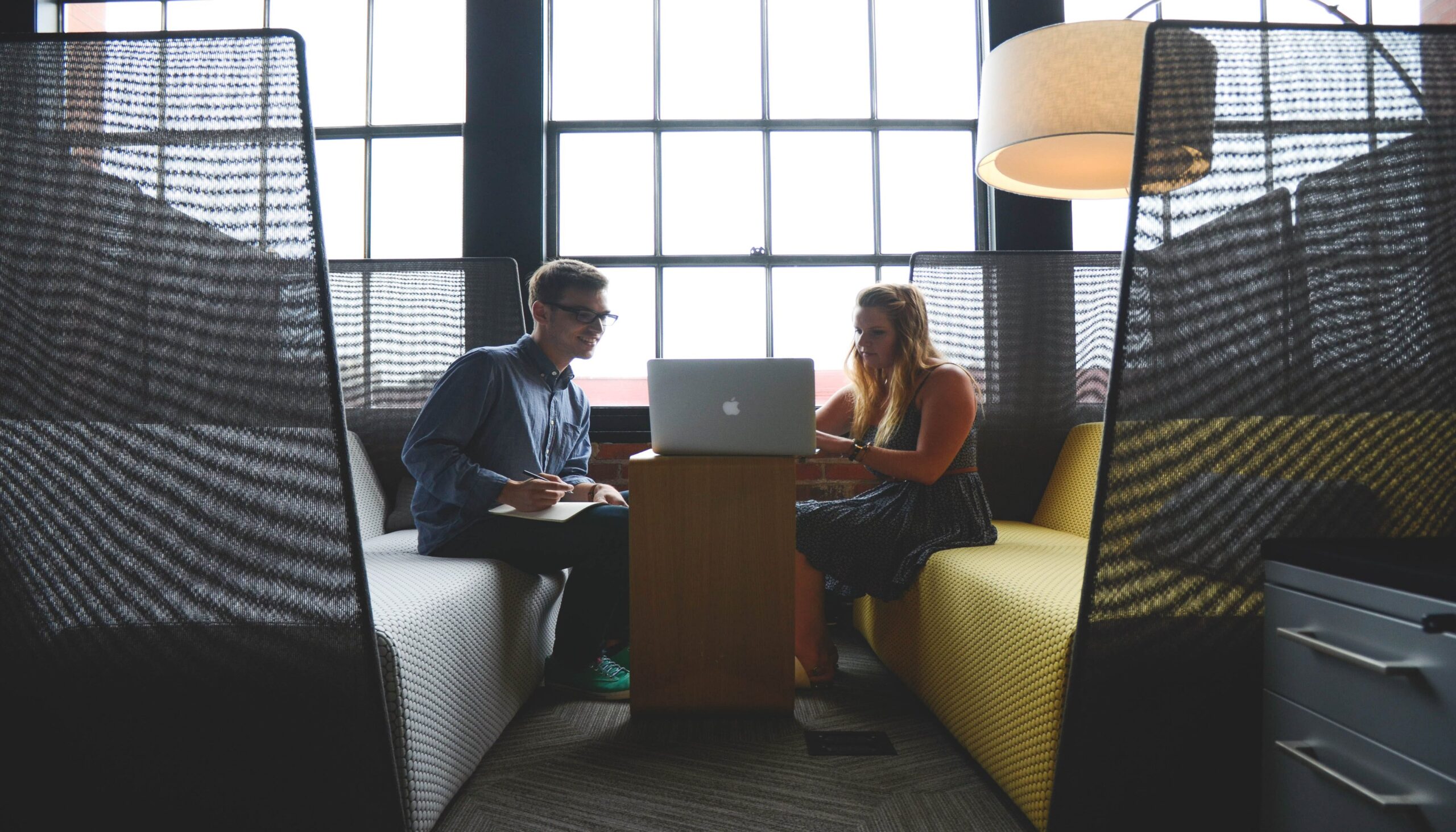 young man and woman discussing providing human resource services to businesses