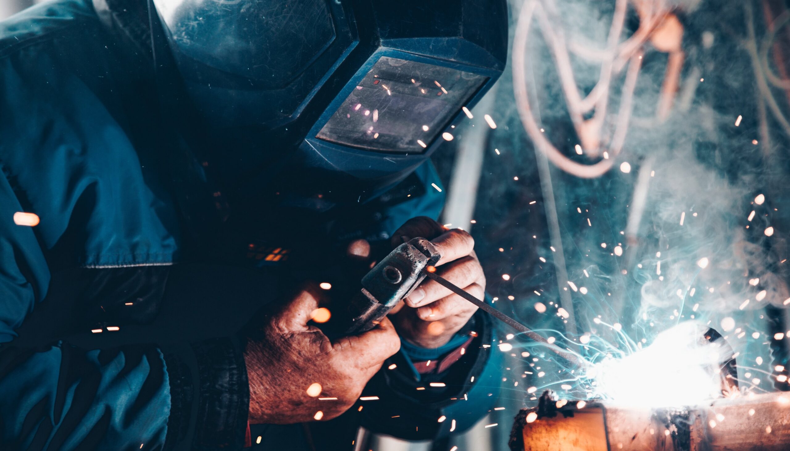 man welding who must comply with Australian workplace laws