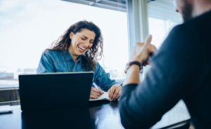 Caucasian female reviewing a DISC profile with a male colleague