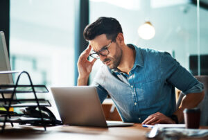 Psychosocial Risk Assessment Survey. Businessman suffering from a psychosocial hazard due to stress caused by work deadlines.
