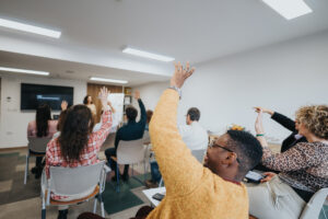 Interactive HR Consulting Melbourne workshop session with enthusiastic participants raising hands
